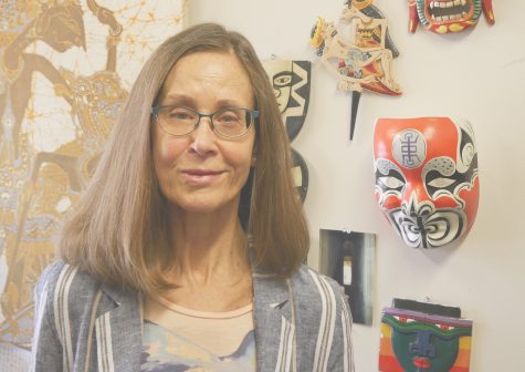 Professor Mimi Harvey in her o ice which she's decorated with art from her travels around the world.