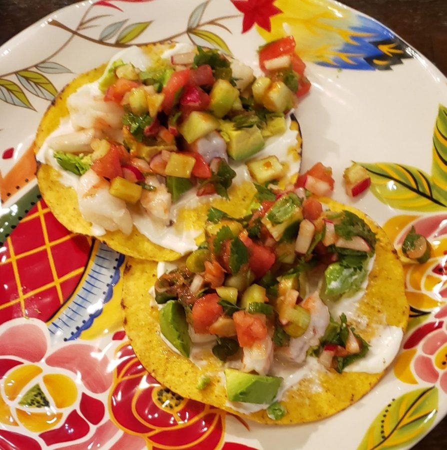 Shown here are 2 shrimp ceviche tostadas with mayonnaise and avocado, ready to eat.