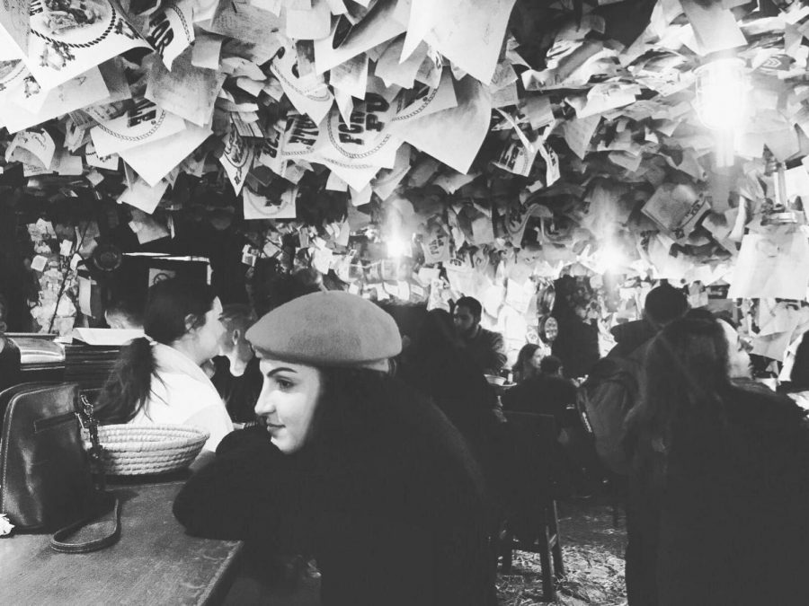 Author Larissa Odabai sits at the For Sale Pub in Budapest; where no one leaves without sharing their words on the walls, ceiling or floor.