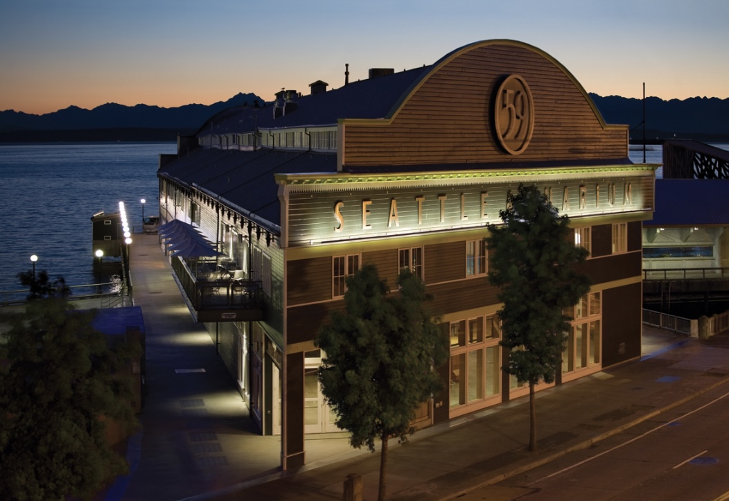 The Seattle Aquarium main building on Pier 59 at sunset. The entire aquarium spans piers 59 and 60, and expansion is underway to connect to Pike Place Market across Alaskan Way.