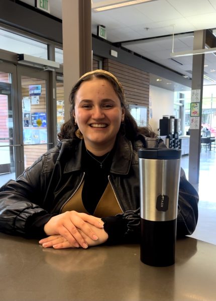 Anna Artamonova, SCC nursing student, showing her Starbucks stainless steel cup while waiting for your friends at the PUB building.