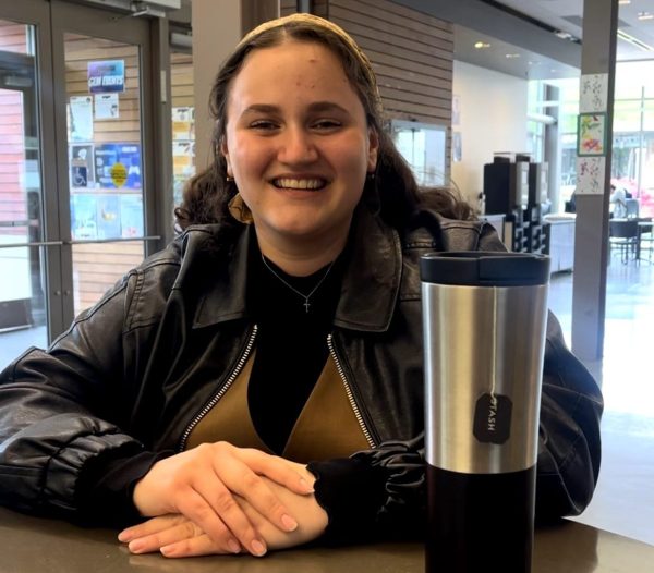 Anna Artamonova, SCC nursing student, showing her Starbucks stainless steel cup while waiting for your friends at the PUB building.