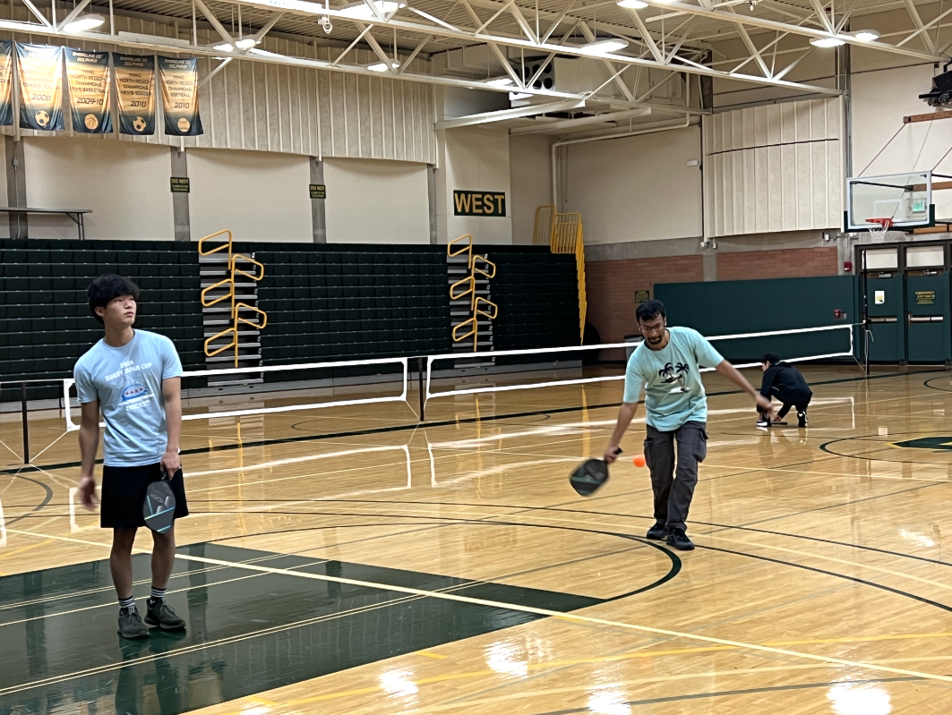 Open house attendees in the midst of a game of pickleball.