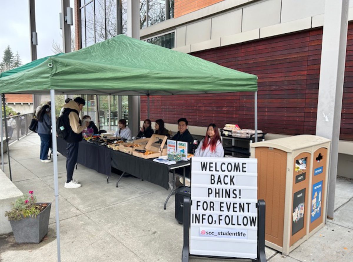 The student life’s booth in front of the PUB 9000 Building handing out food and beverages for students to enjoy.