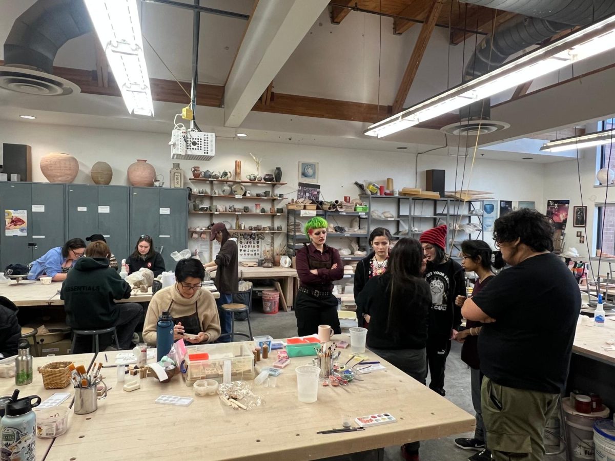 A member of the Clay Club welcoming the group of students and explaining the basics.