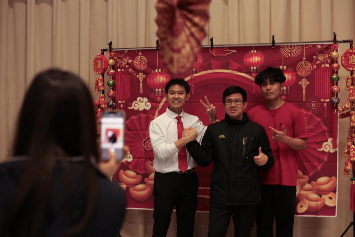 Students prepare to have their photo taken at a photo booth.