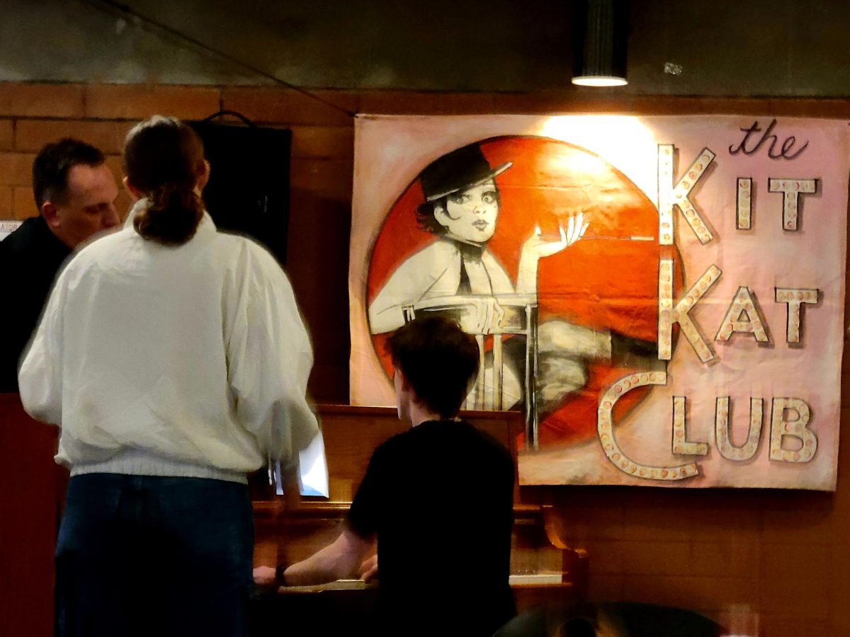 The Kit Kat Club Poster in the lobby of the Theater. The rest of the signs for the fictional cabaret troupe use the spelling Kit Kat Klub to reference the KKK.