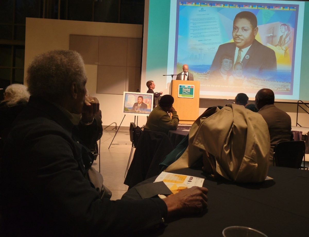 Audiences turn towards the opening speaker, Ernest B. Johnson. Johnson, known as Dr. J, was an Assistant Dean of Social Sciences and a tenured professor of Multicultural Studies, African American History and African Culture here before he retired.