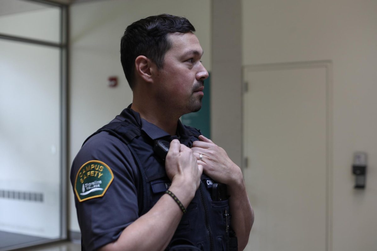 A security guard on campus posing with his new uniform.